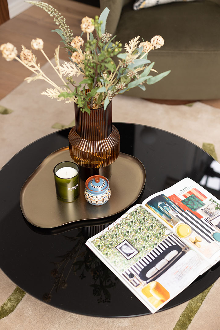 Coffee table decor with a vase, candle, and a magazine-20