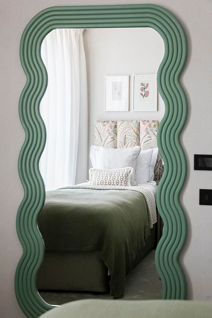 KOA HOUSE, Wavy green mirror reflecting bedroom view – 41