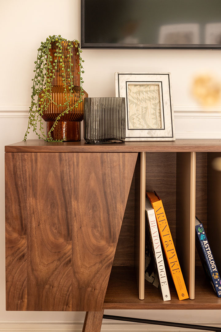 Modern TV stand with decorative vases, a frame, and books-21