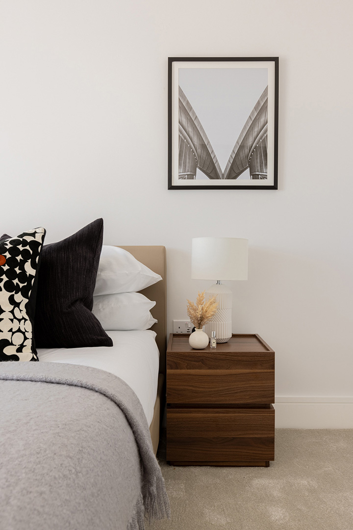Modern bedroom with a framed photo, a lamp, and a nightstand-35
