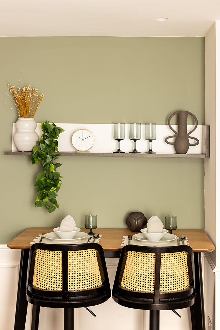 Small dining nook with a green wall and a shelf-24