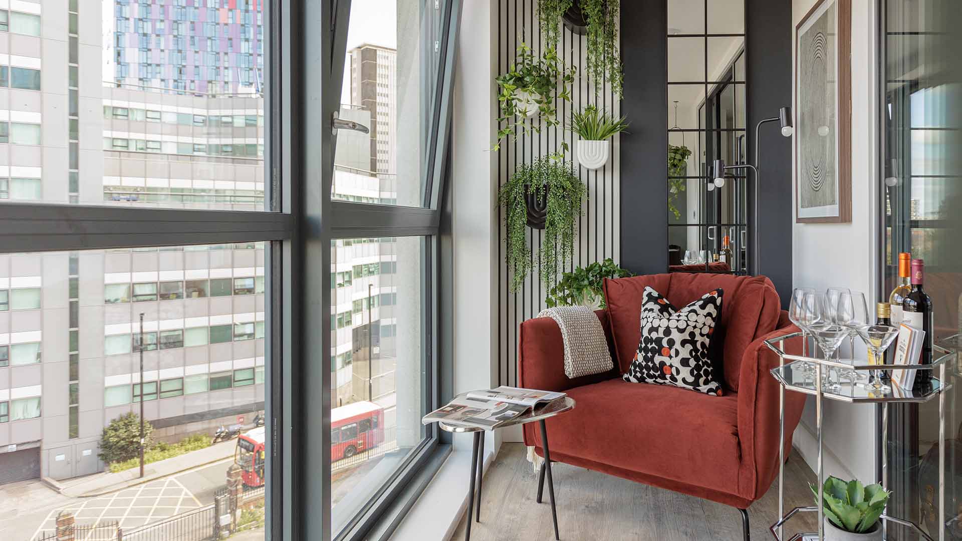 Haydon development lounge area with red chair & bar cart