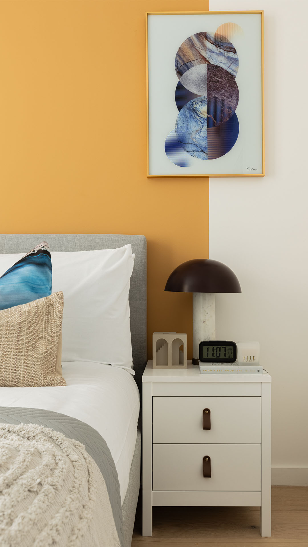 Bedroom with white nightstand and art of 10 Verdica show flats