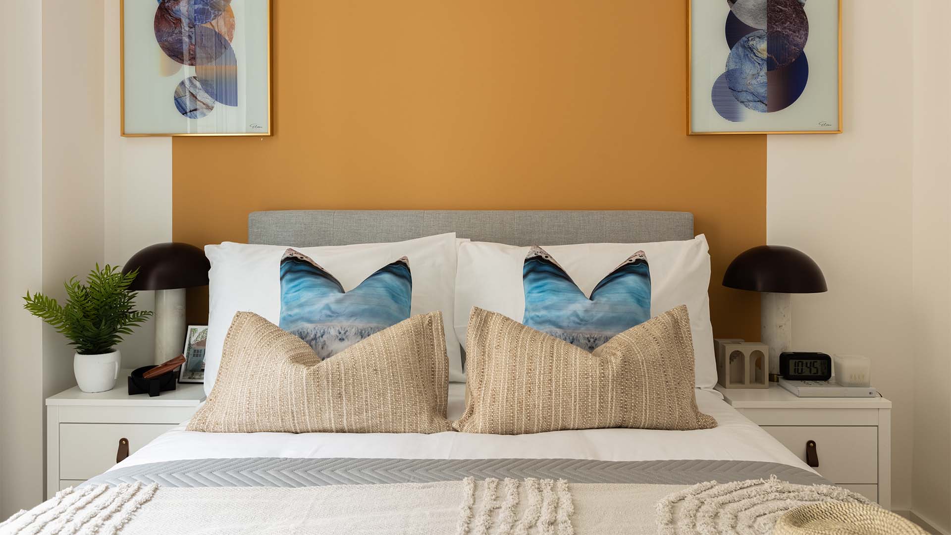 Decorated bed with plant and framed art of 10 Verdica show flats