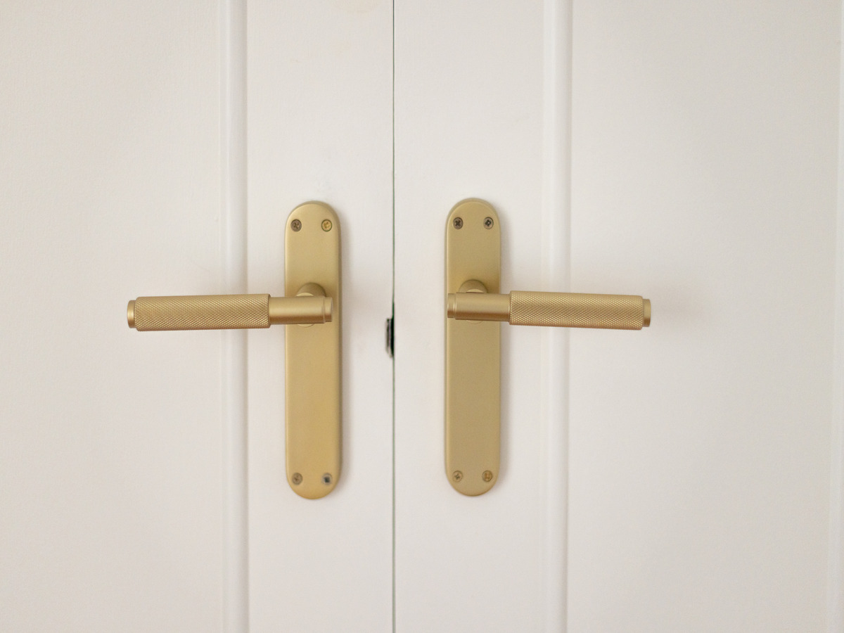 After refurbishment: brass lever handles on white doors