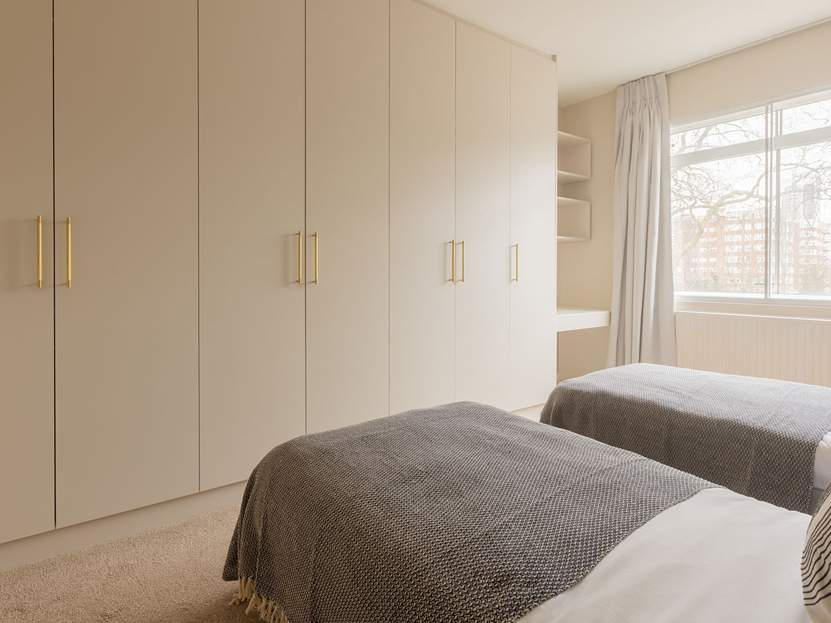 Stylish rental bedroom: fitted storage and soft bedding