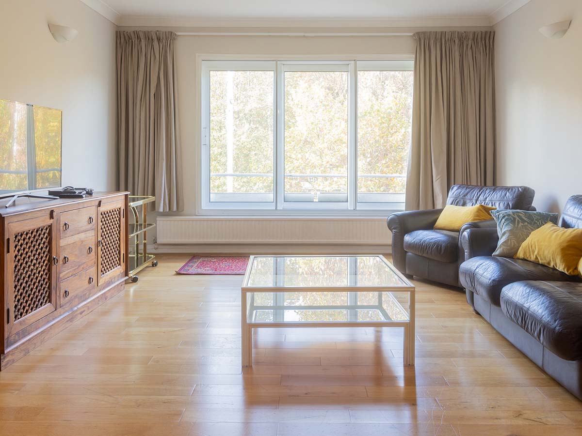 Before: worn leather sofa and glass coffee table in lounge