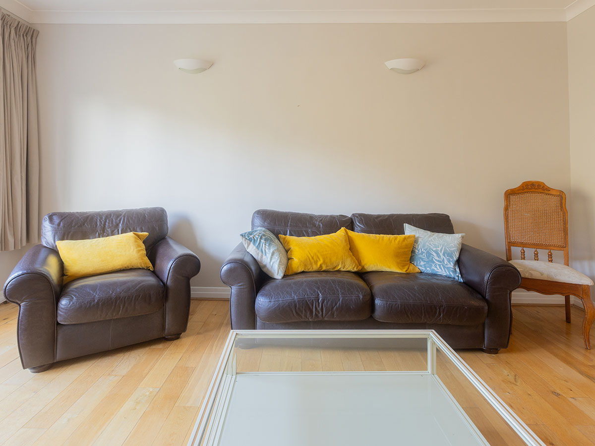 Before: living room with leather sofa and armchair